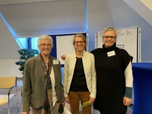 Drei Frauen stehen nebeneinander und blicken in die Kamera